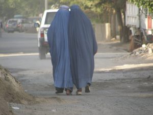 Two Afghan women walking down the road